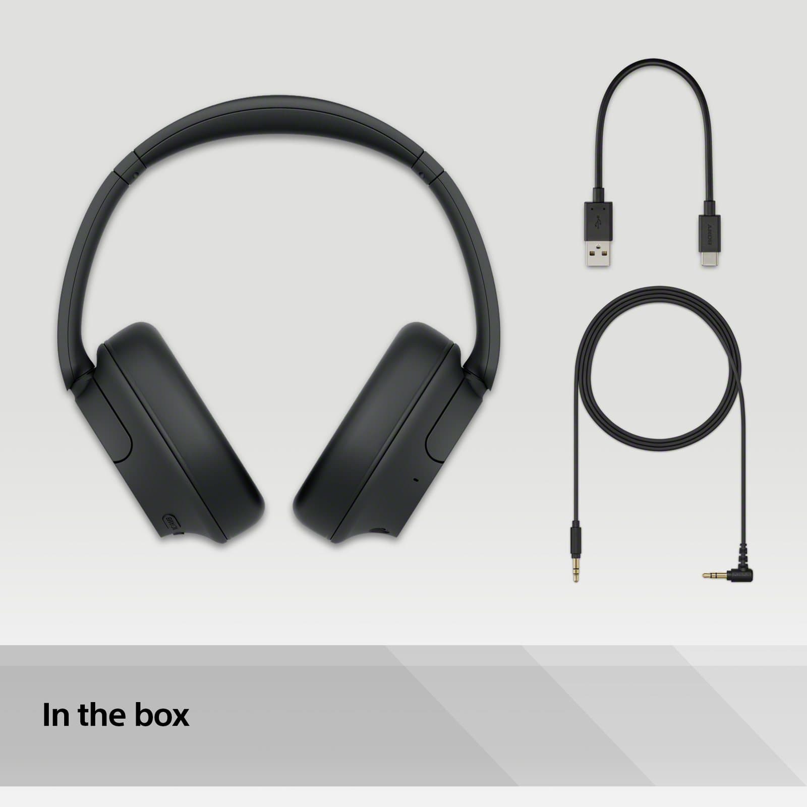 Sony WH-CH720N headphones, shown in black, with the USB cable and the headphone connection cable